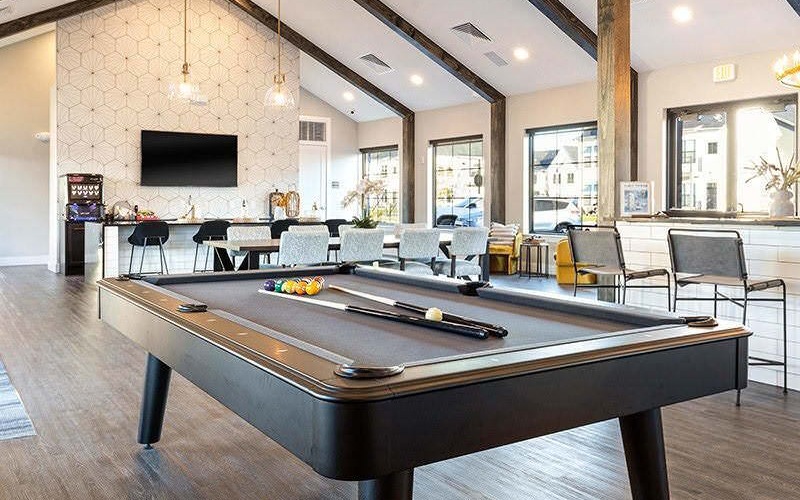 billiards table in clubhouse with vaulted ceiling