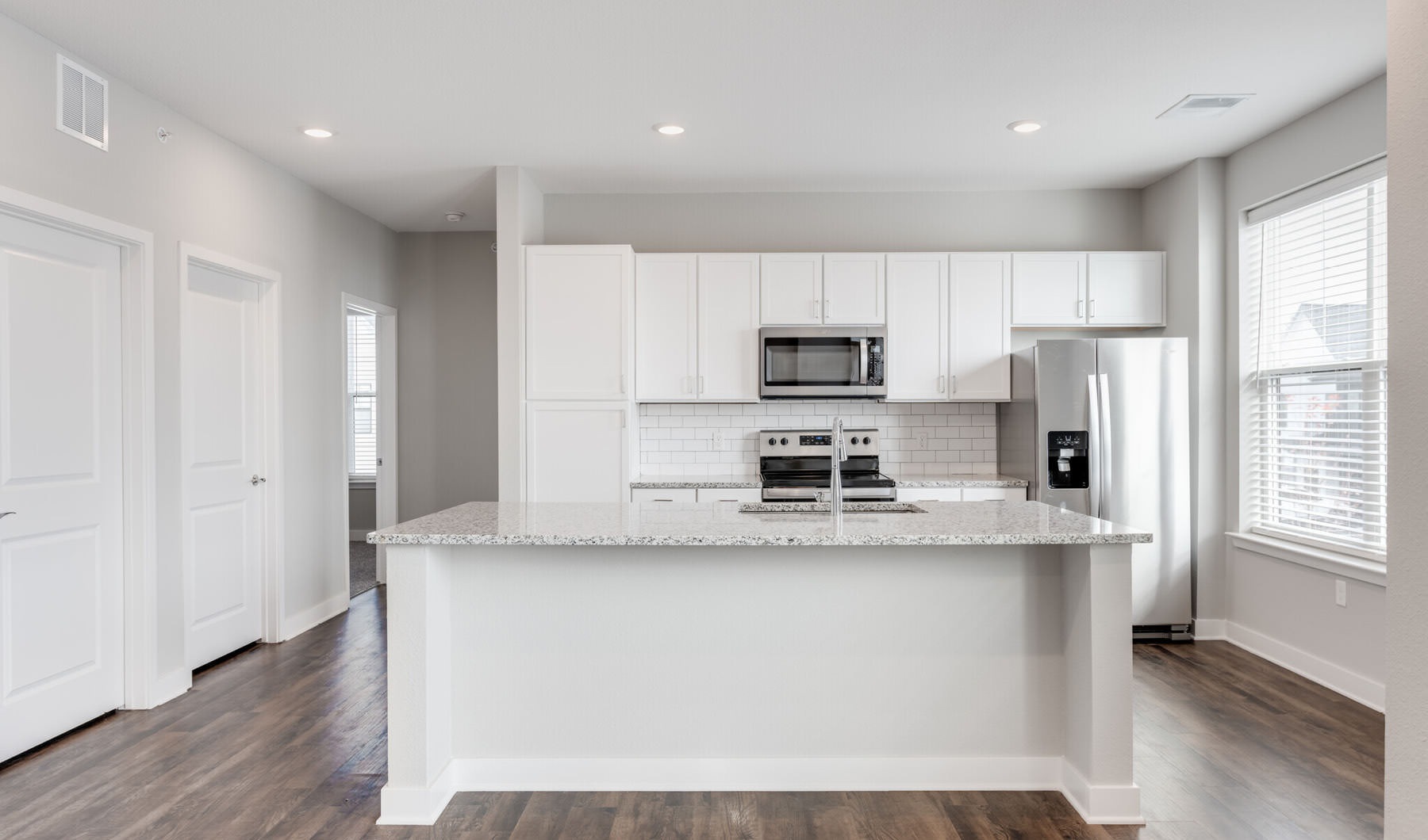Living Begins Here large island in open kitchen with oversized window